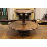 A MAHOGANY TWO TIER CAKE-STAND, with turned and fluted column support, ,21" x 16" approx