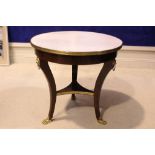 A GOOD QUALITY MARBLE TOPPED CENTRE TABLE, raised on tripod leg, with brass mounted lion heads,
