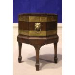 A GOOD QUALITY REGENCY BRASS BOUND MAHOGANY WINE COOLER, octagonal in shape, with liner, lion head
