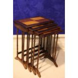 A GOOD QUALITY KINGWOOD PARQUETRY INLAID NEST OF 4 TABLES, raised on ring turned leg, 22" x 15" x
