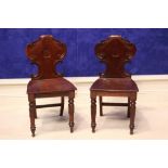 A PAIR OF 19TH CENTURY IRISH MAHOGANY HALL CHAIRS, with carved scroll motif to the back, with curled