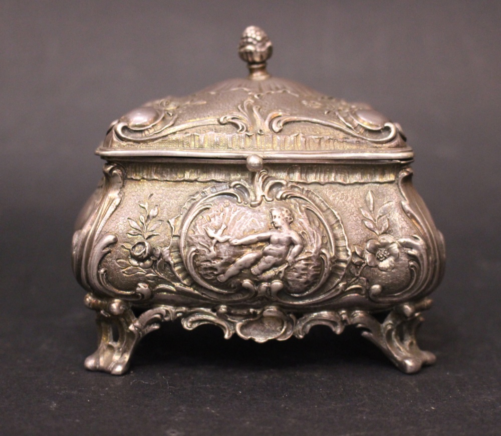 A DUTCH SILVER TRICKET BOX, with gilt interior, the body decorated all over with repoussé effect,