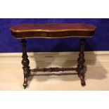 A LATE 19TH / EARLY 20TH CENTURY SERPENTINE SHAPED CENTRE / HALL TABLE, raised on a pair of turned