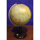 A MID CENTURY TERRESTRIAL GLOBE, on a wooden stand, with a built in compass, 21” high approx