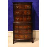 AN EARLY 20TH CENTURY MAHOGANY BOW FRONTED CHEST ON CHEST, 6 drawers, and slide, raised on splayed