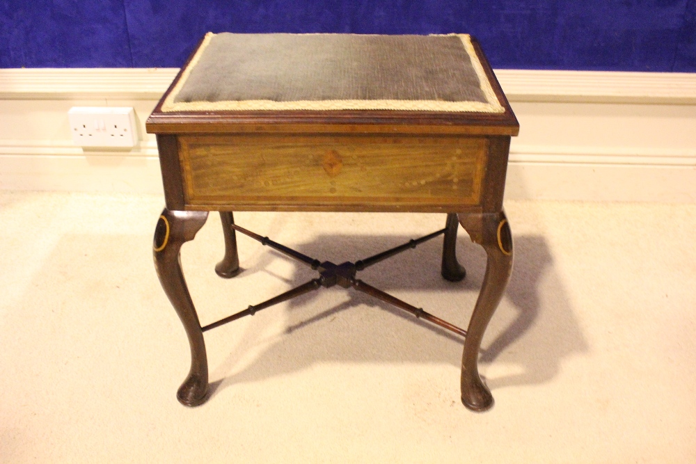 AN EDWARDIAN MAHOGANY & MARQUETRY INLAID LIFT TOP PIANO STOOL, raised on cabriole leg, united by