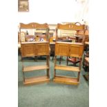 A PAIR OF NEATLY SIZED OAK OPEN BOOKCASES, each with a two door cabinet to the centre, pierced