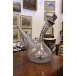 A GLASS DECANTER, with applied silver floral and grape vine decoration, with stopper, in excellent