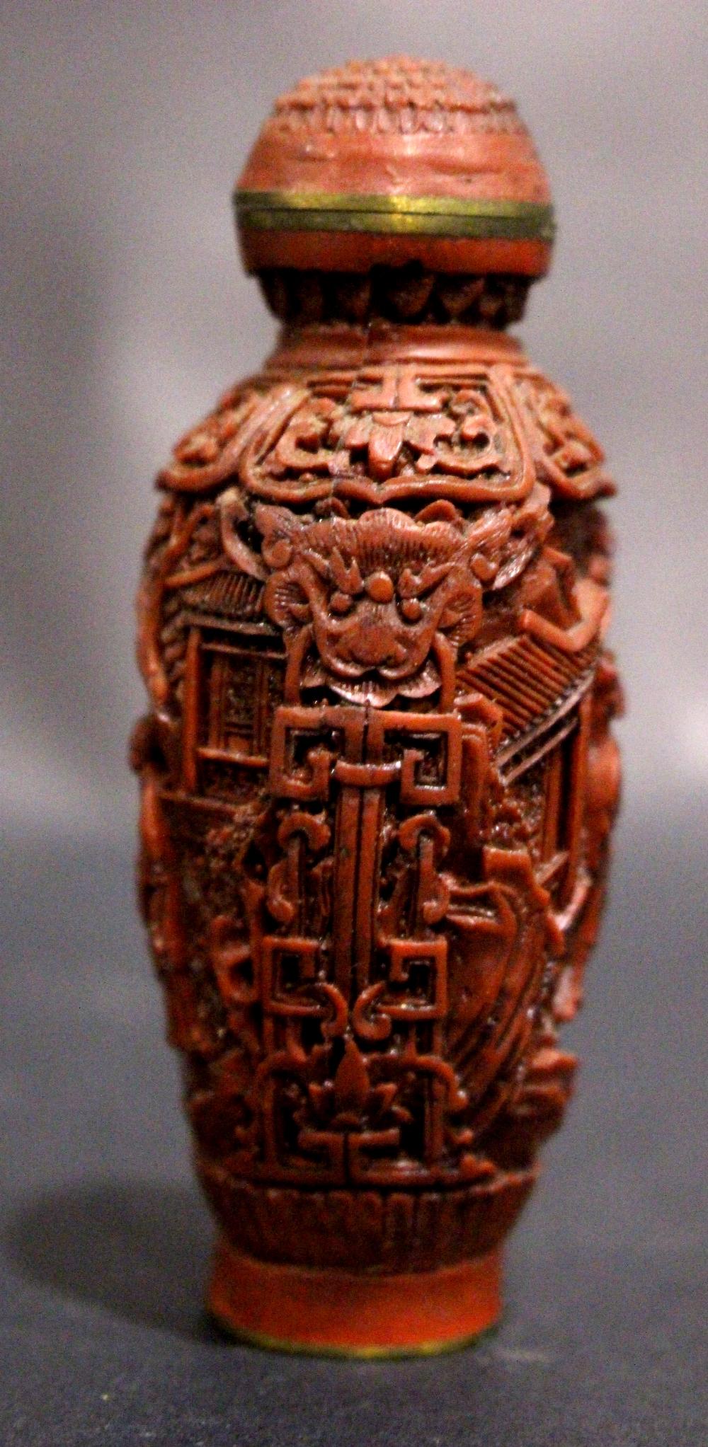 A CARVED CINNABAR & BRASS SNUFF BOTTLE, with inlaid brass character marks to the base, decorated - Image 3 of 7