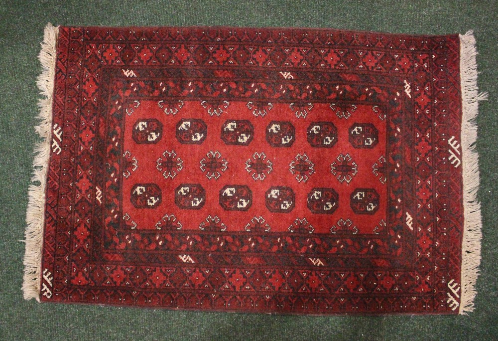 A SMALL FLOOR RUG, with main ground red, multi border, Bokhara style design, 49" x 31" approx