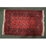 A SMALL FLOOR RUG, with main ground red, multi border, Bokhara style design, 49" x 31" approx
