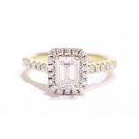 A STUNNING 18CT YELLOW GOLD EMERALD CUT HALO DIAMOND RING, with central emerald cut diamond