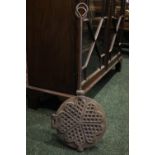 AN ANTIQUE CAST IRON WAFFLE PRESS