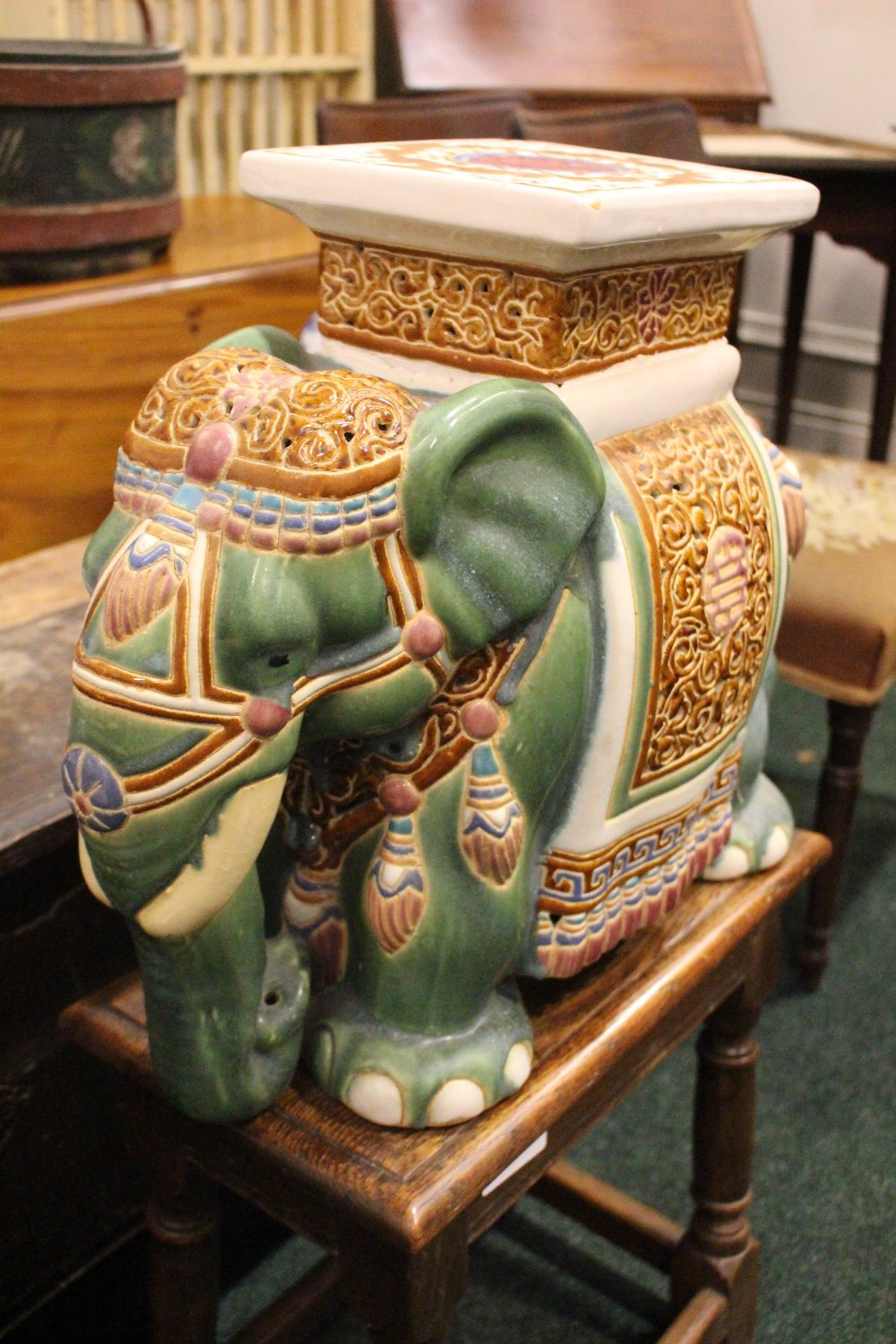 A CERAMIC JARDINERE / POT STAND IN THE FORM OF AN ELEPHANT, dressed in robes with a square seat as - Image 3 of 5