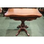 A GOOD QUALITY FOLD OVER CARD TABLE, serpentine shaped, raised on turned and carved column support