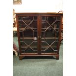 AN ASTRAGAL GLAZED TWO DOOR FLOOR BOOKCASE, with shelved interior sitting on bracket feet, 40" x 13"
