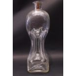A ‘DEWARS WHISKY’ PINCHED ‘HOUR GLASS’ DECANTER, with corked stopper, having an Italian coin on