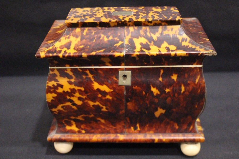 A REGENCY TORTOISE SHELL TEA CADDY, veneered with figured tortoise shell panels divided by silver