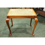 A LOW RISE RATTAN TOPPED SIDE TABLE, raised on Queen Anne shaped pad foot legs, 22" x 16" x 18"