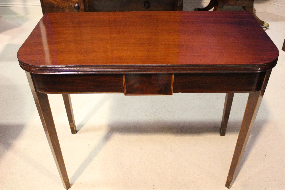 A VERY FINE GEORGE III FOLD OVER TEA TABLE, with inlaid detail, circa 1790, reeded rim, raised on