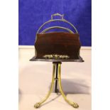 AN EDWARDIAN ROSEWOOD & BRASS CANTERBURY STAND, revolving, with brass railed racks, raised on