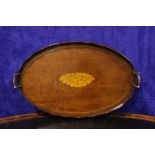 A 19TH CENTURY MAHOGANY OVAL TRAY with raised scalloped sides, brass handles and inlaid conch