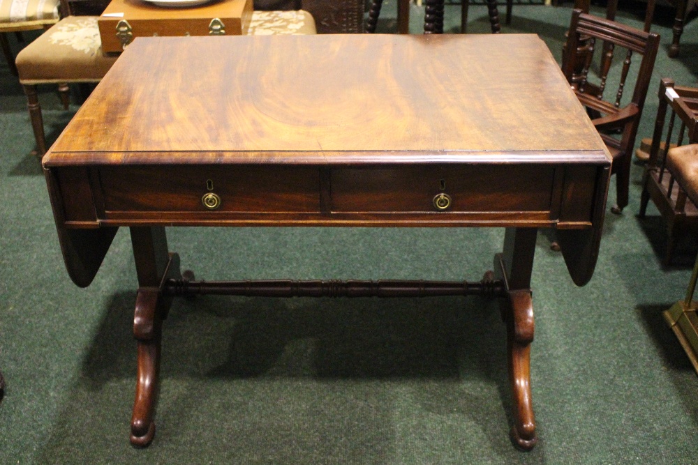 A DROP LEAF SOFA TABLE, with two frieze drawers, raised on a pair of side pod supports with