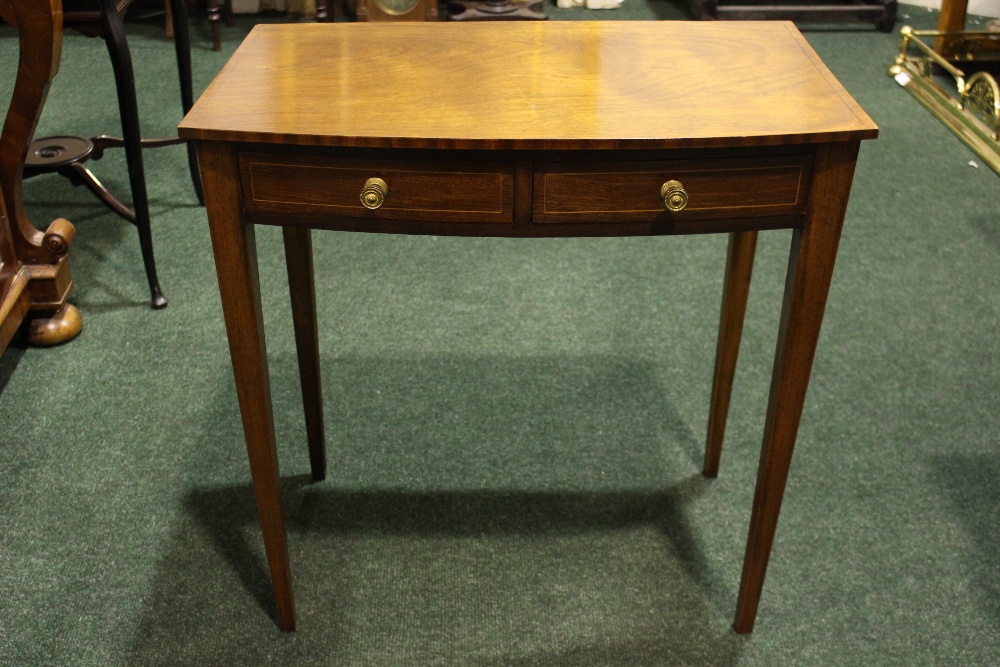 AN EARLY 20TH CENTURY MAHOGANY BOW FRONTED SIDE TABLE, with a pair of string inlaid frieze