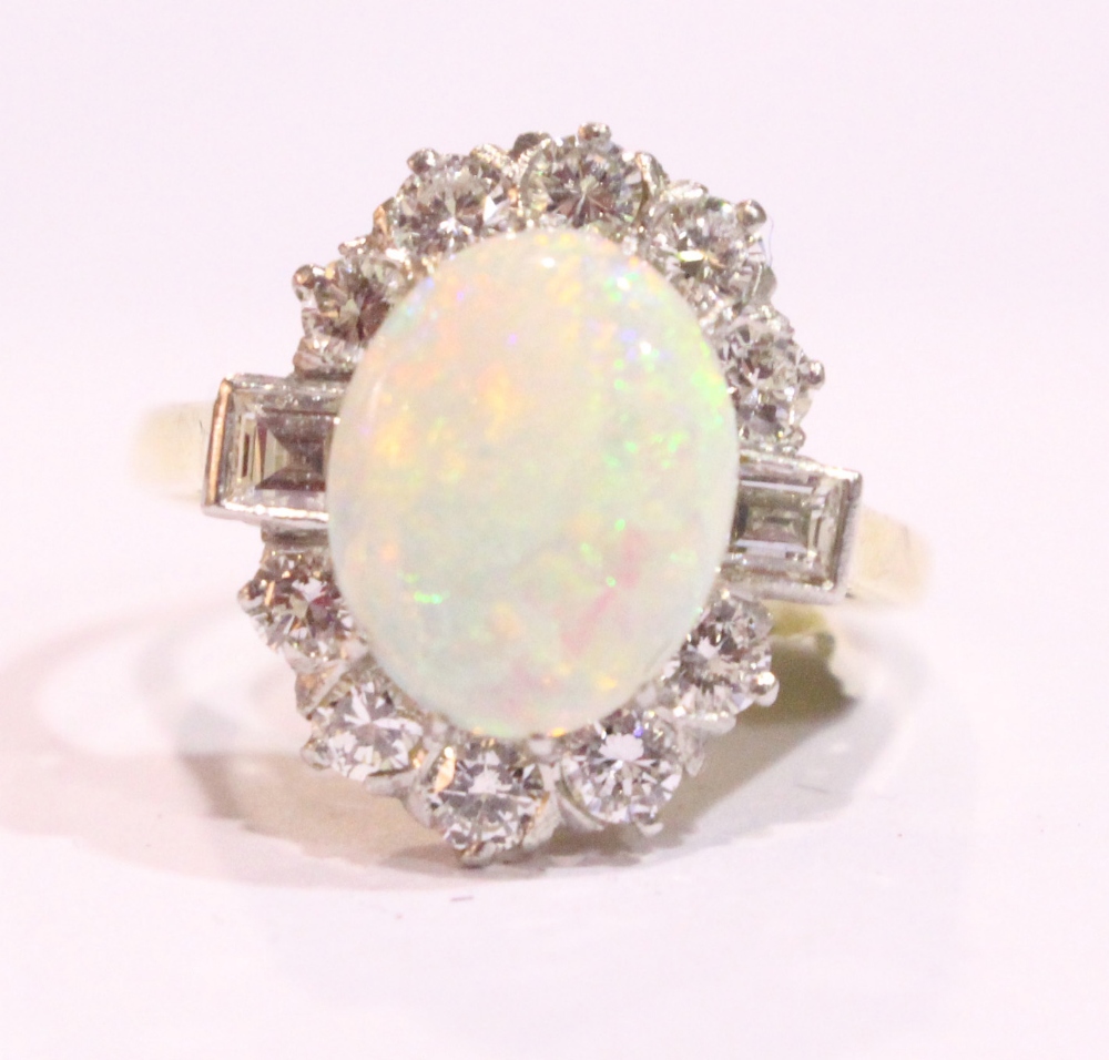 AN 18CT YELLOW GOLD FIRE OPAL & DIAMOND CUSTER RING, surrounded by round brilliant cut and