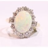 AN 18CT YELLOW GOLD FIRE OPAL & DIAMOND CUSTER RING, surrounded by round brilliant cut and