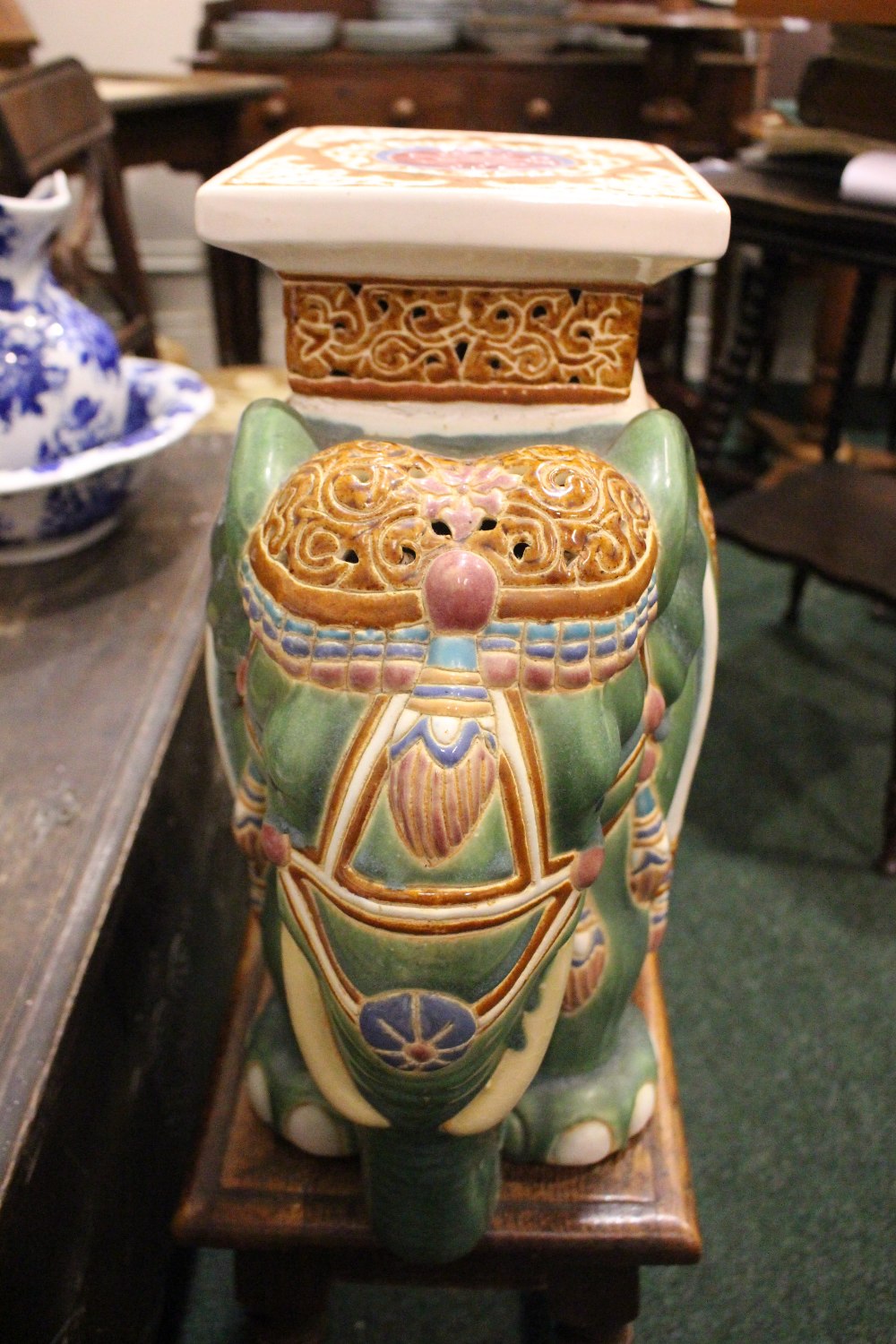 A CERAMIC JARDINERE / POT STAND IN THE FORM OF AN ELEPHANT, dressed in robes with a square seat as - Image 4 of 5