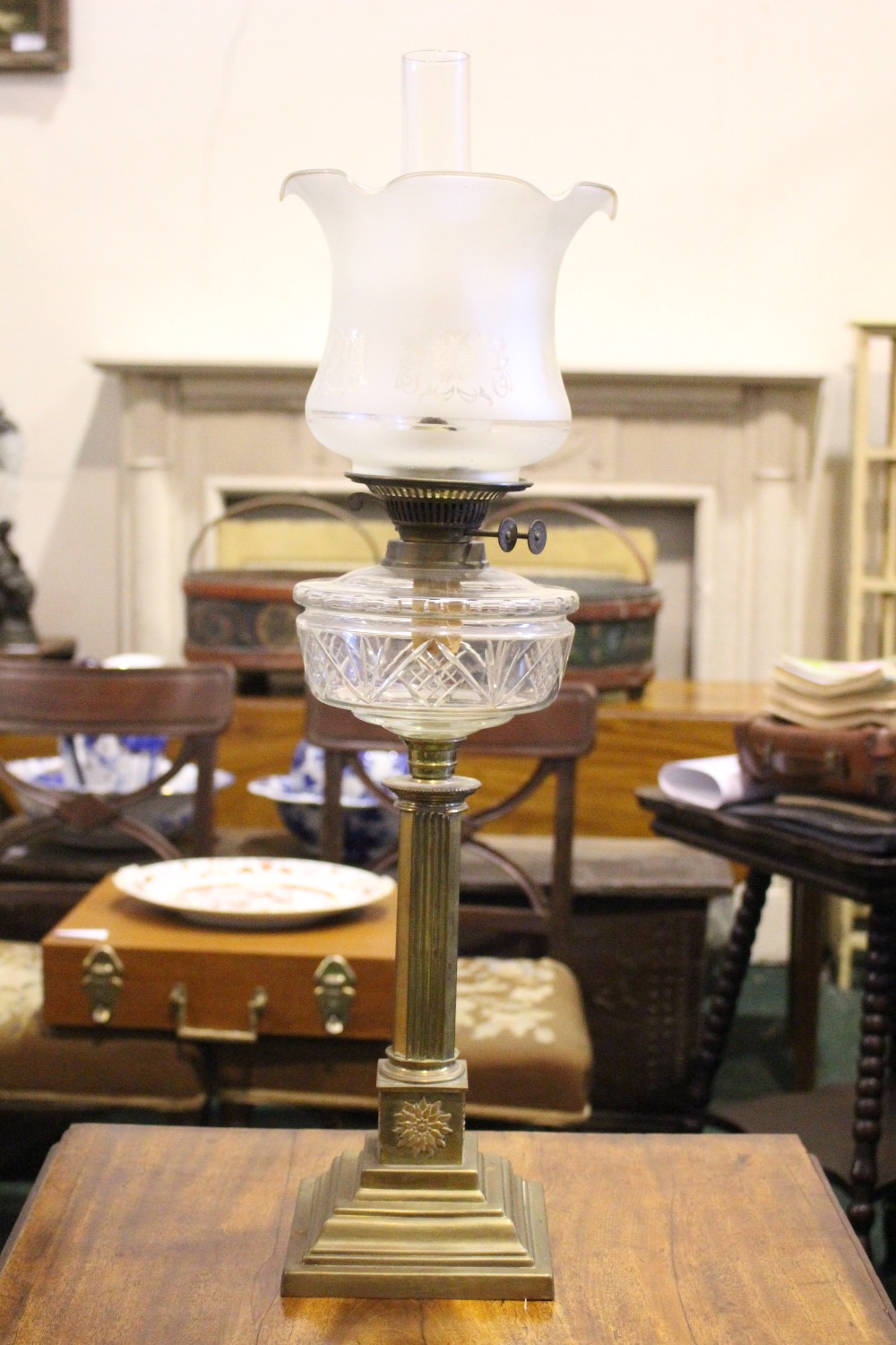 A VICTORIAN BRASS & GLASS OIL LAMP, with column base, clear glass reservoir, frosted glass shade &