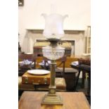 A VICTORIAN BRASS & GLASS OIL LAMP, with column base, clear glass reservoir, frosted glass shade &