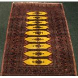 A SMALL FLOOR RUG, with 9 mustard coloured central medallions, multi border, 59" x 37" approx