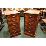 A PAIR OF VICTORIAN 5 DRAWER CHESTS, with carved pull handles, on platform base, graduated