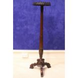 A VICTORIAN MAHOGANY TORCHÉRE STAND, with octagonal top having a carved foliage rim, and reeded &