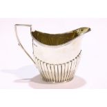 AN EARLY 20TH CENTURY SILVER CREAMER / JUG, with gilt interior, Sheffield, date letter 'u' for 1912,