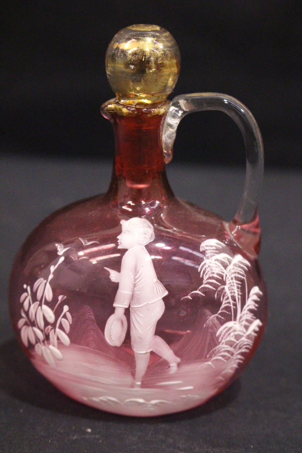 A 'MARY GREGORY' STYLE MINIATURE DECANTER, with stopper, enamelled image of a boy standing in a