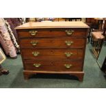 A GEORGIAN CHEST OF DRAWERS, oak lined graduated drawers with brass handles, raised on bracket feet,