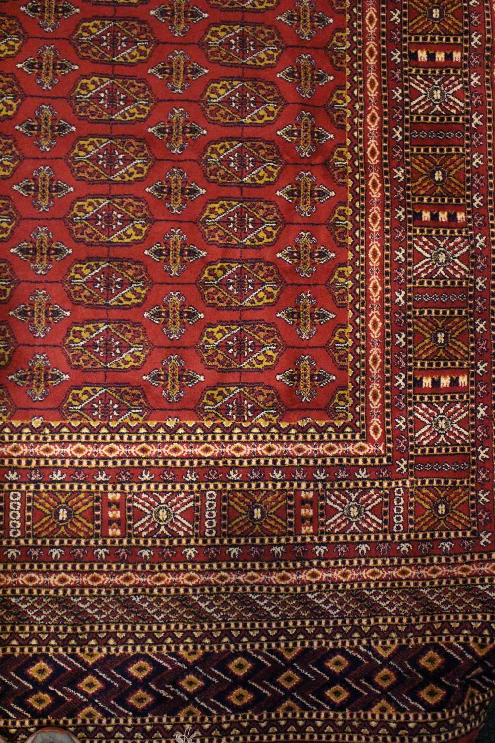 A BOKHARA STYLE FLOOR RUG, with red main ground, multi borders, 94" x 63" approx - Image 2 of 2