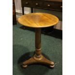 A CIRCULAR SIDE / LAMP TABLE, raised on a turned column support, on tripod base, with bun feet on