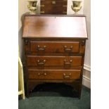 A SECRETAIRE / BUREAU with drop down front, having sectioned interior, over 3 drawers, raised on