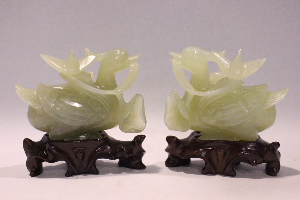 A MATCHING PAIR OF JADE ‘DUCK & LOTUS’ CARVINGS, each with exceptional detail, the recumbent ducks