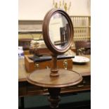 A GENTLEMAN'S DRESSING STAND, with adjustable mirror, raised on turned column support on a tripod