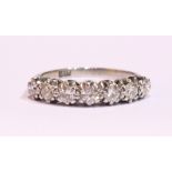 AN 18CT WHITE GOLD 7 STONE DIAMOND RING, 1.50 cts