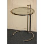 After Eileen Gray model E1027, a chrome and glass occasional table with circular adjustable top on