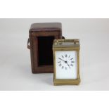 A glass and bevelled glass carriage clock, the movement stamped France, white enamel dial with Roman