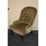 A Victorian button back upholstered nursing chair on turned legs and castors
