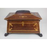 A large 19th century sarcophagus tea caddy, the carved and inlaid cover enclosing two wooden