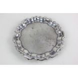 A George V silver waiter card tray with piecrust border and engraved initial and date to centre,